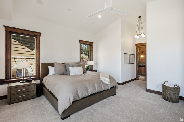 7885 North Rabbitbrush Court, Unit 13 Park City, UT 84098 - Photo 26 of 88 Carpeted interior space featuring a ceiling fan with integrated lighting, wood-trimmed windows, a contemporary chandelier, and a wood-paneled door