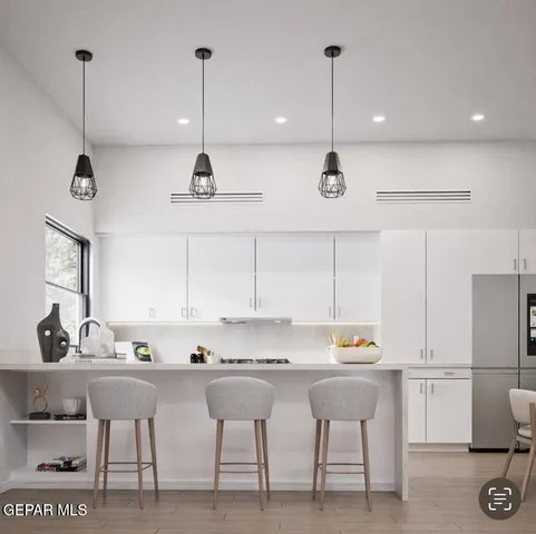 a kitchen with a table chairs stove and cabinets