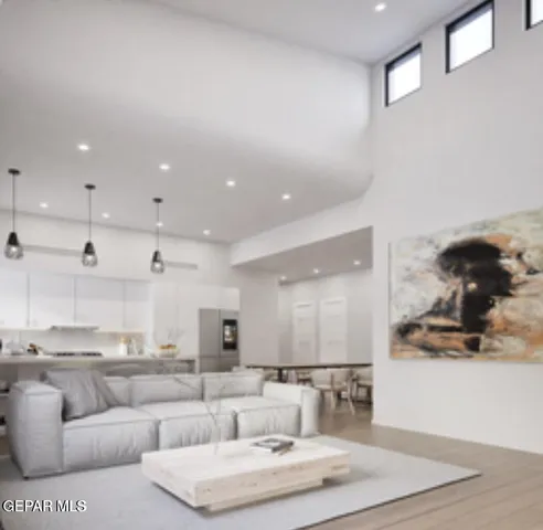 a living room with furniture and kitchen view