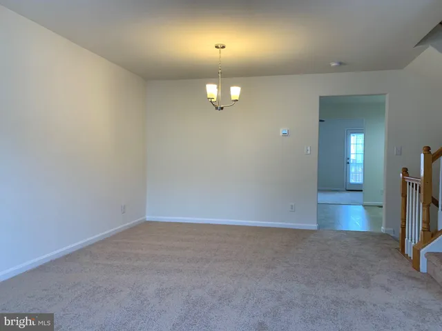 an empty room with wooden floor and mirror