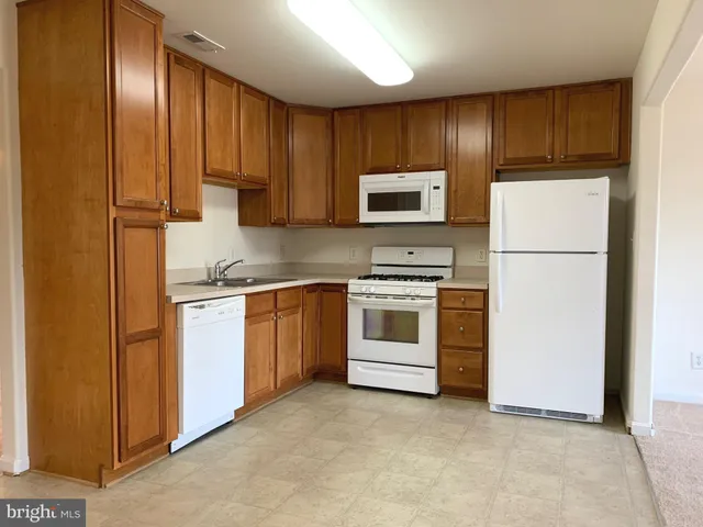 a kitchen with sink cabinets stainless steel appliances and microwave