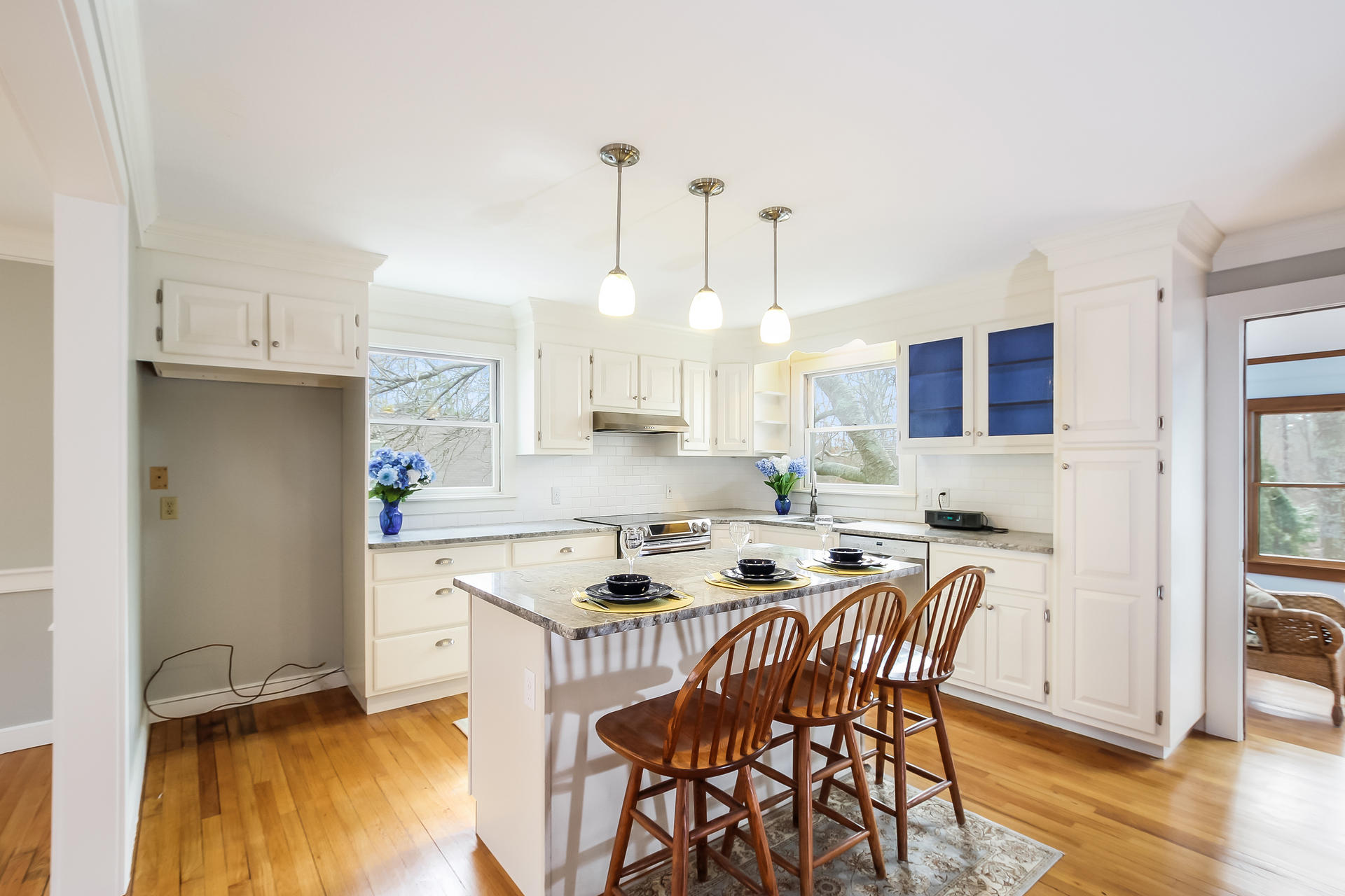 13 Bayview Road East Sandwich, MA 02537 - Photo 3 of 35 a kitchen with stainless steel appliances kitchen island granite countertop a stove a sink a refrigerator and a dining table with wooden floor