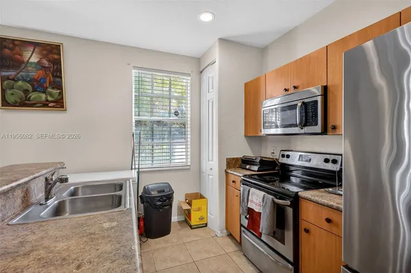 a kitchen with a stove a sink and a microwave