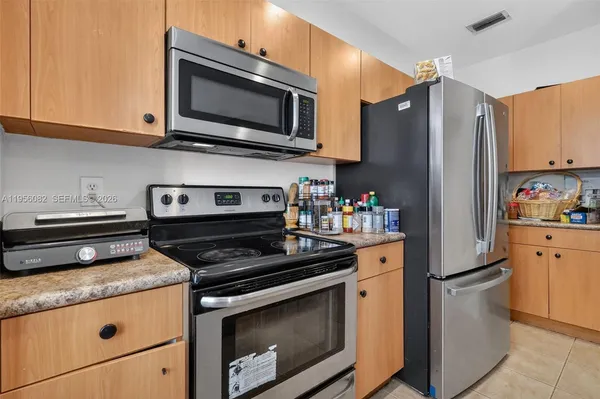 a kitchen with stainless steel appliances a stove a microwave and cabinets