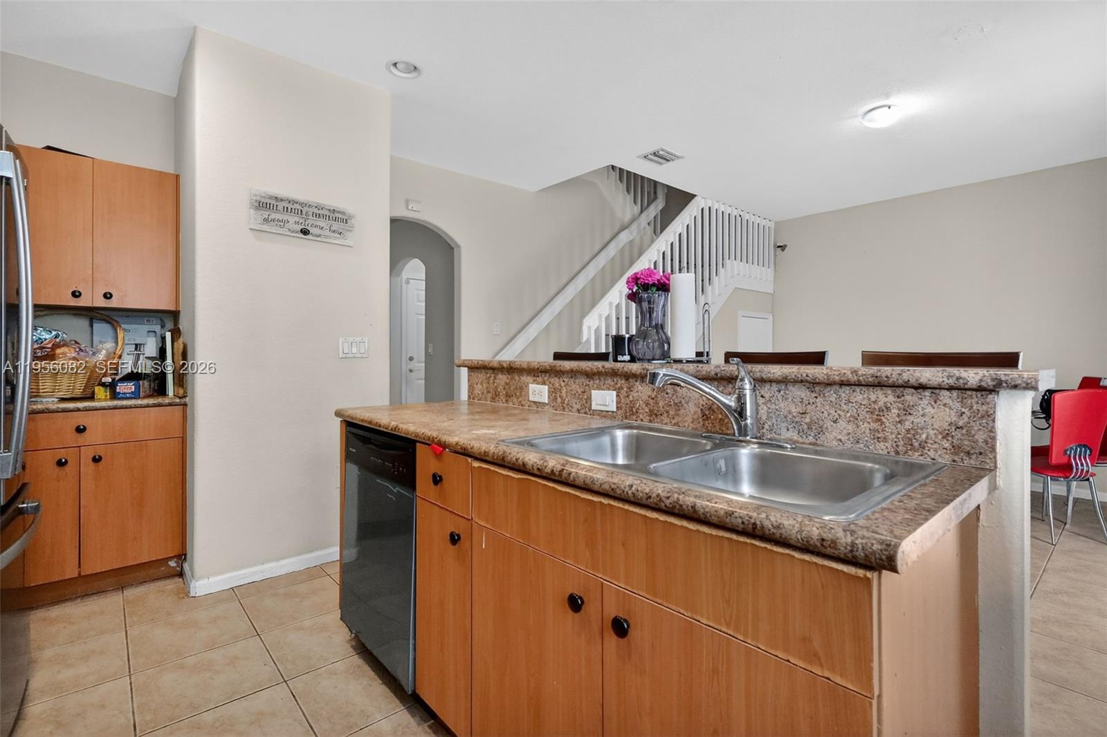 2671 Southwest 85th Terrace, Unit 103 Miramar, FL 33025 - Photo 20 of 49 a kitchen with a sink and a refrigerator