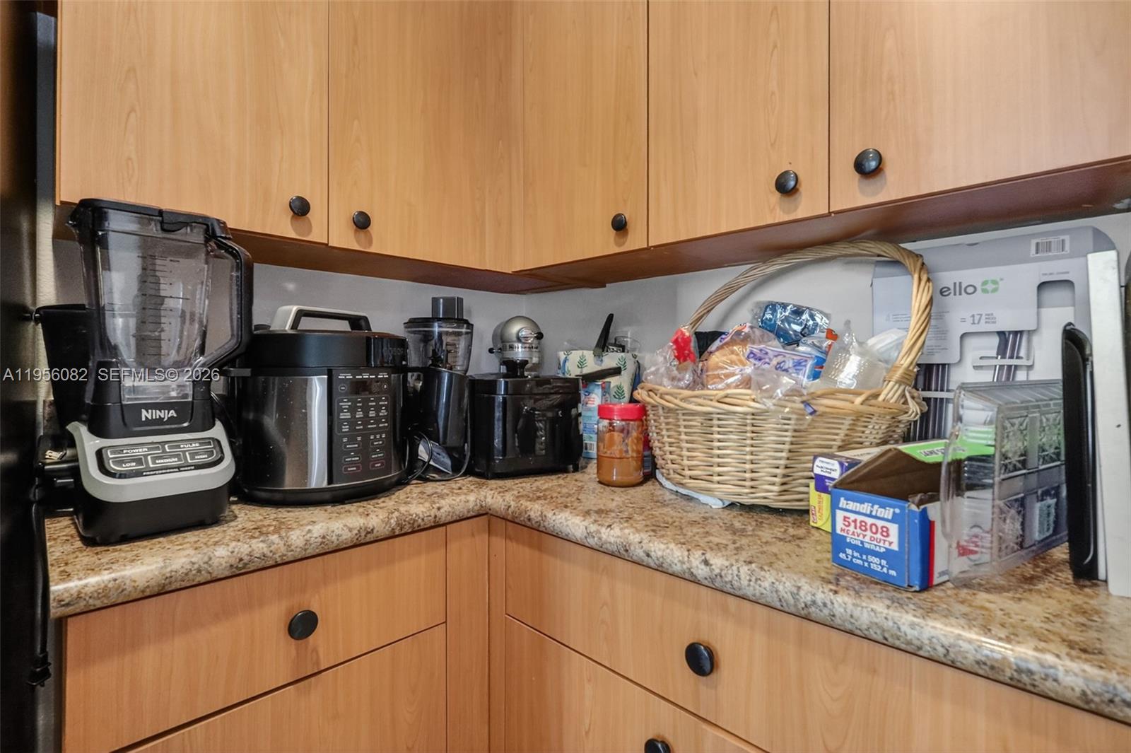 2671 Southwest 85th Terrace, Unit 103 Miramar, FL 33025 - Photo 21 of 49 a kitchen with stainless steel appliances granite countertop a sink and cabinets