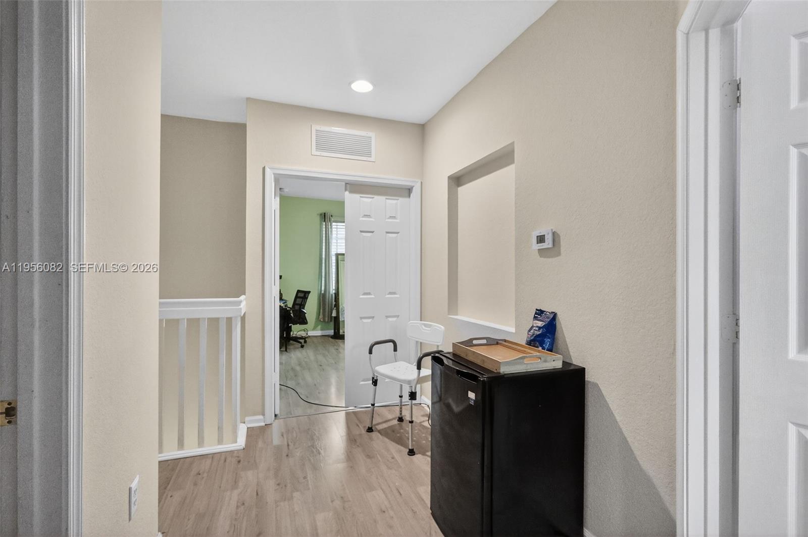 2671 Southwest 85th Terrace, Unit 103 Miramar, FL 33025 - Photo 22 of 49 a view of a hallway with furniture and wooden floor
