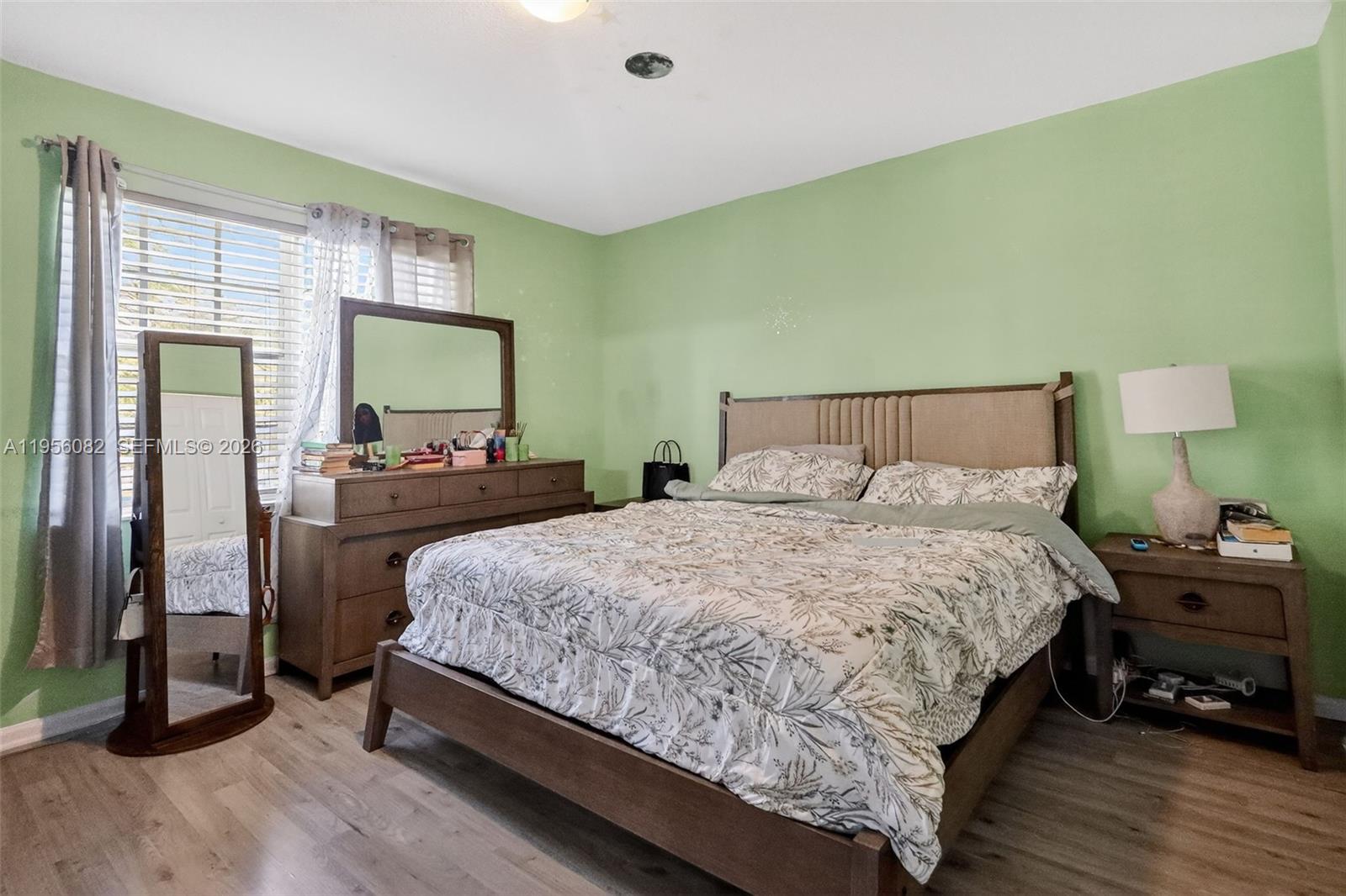 2671 Southwest 85th Terrace, Unit 103 Miramar, FL 33025 - Photo 23 of 49 a bedroom with a bed and a flat tv screen on dresser