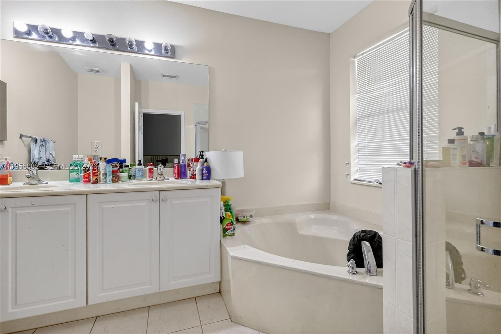 2671 Southwest 85th Terrace, Unit 103 Miramar, FL 33025 - Photo 27 of 49 a bathroom with a tub sink and mirror