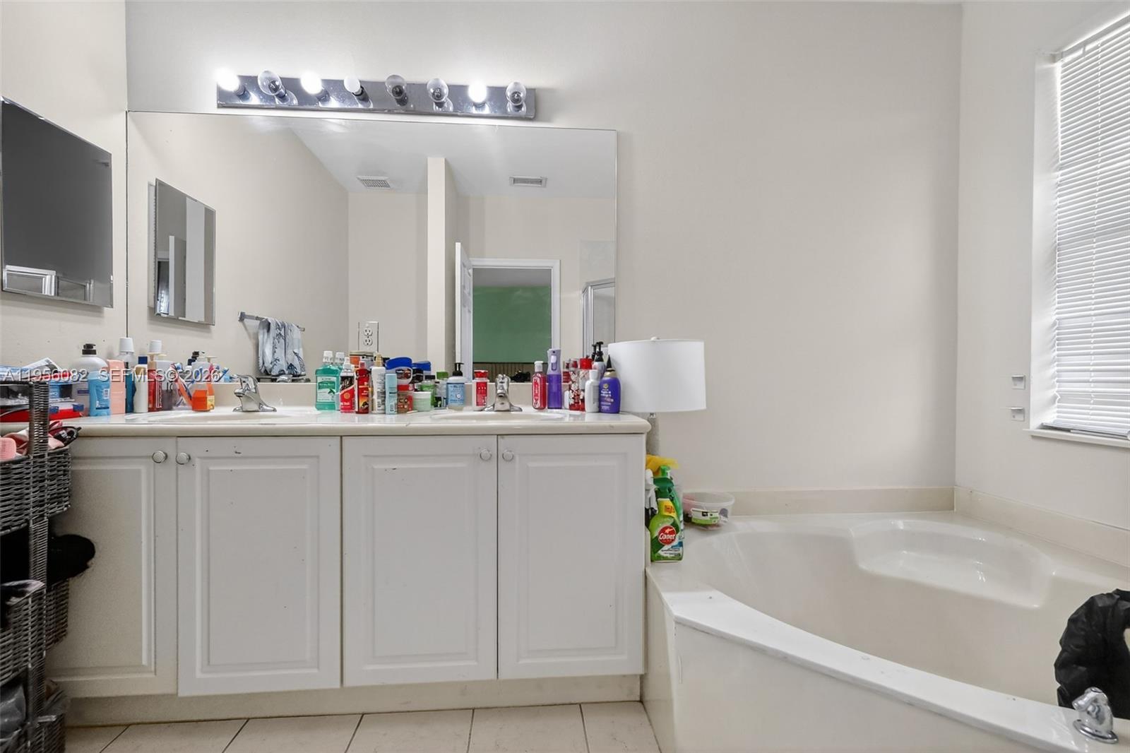 2671 Southwest 85th Terrace, Unit 103 Miramar, FL 33025 - Photo 28 of 49 a bathroom with a tub sink and mirror