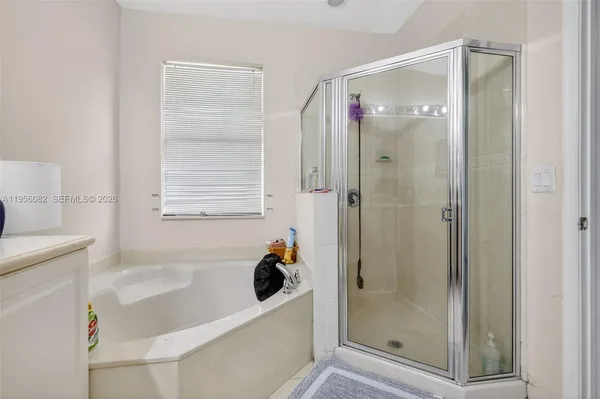 a bathroom with a bathtub a shower and a sink