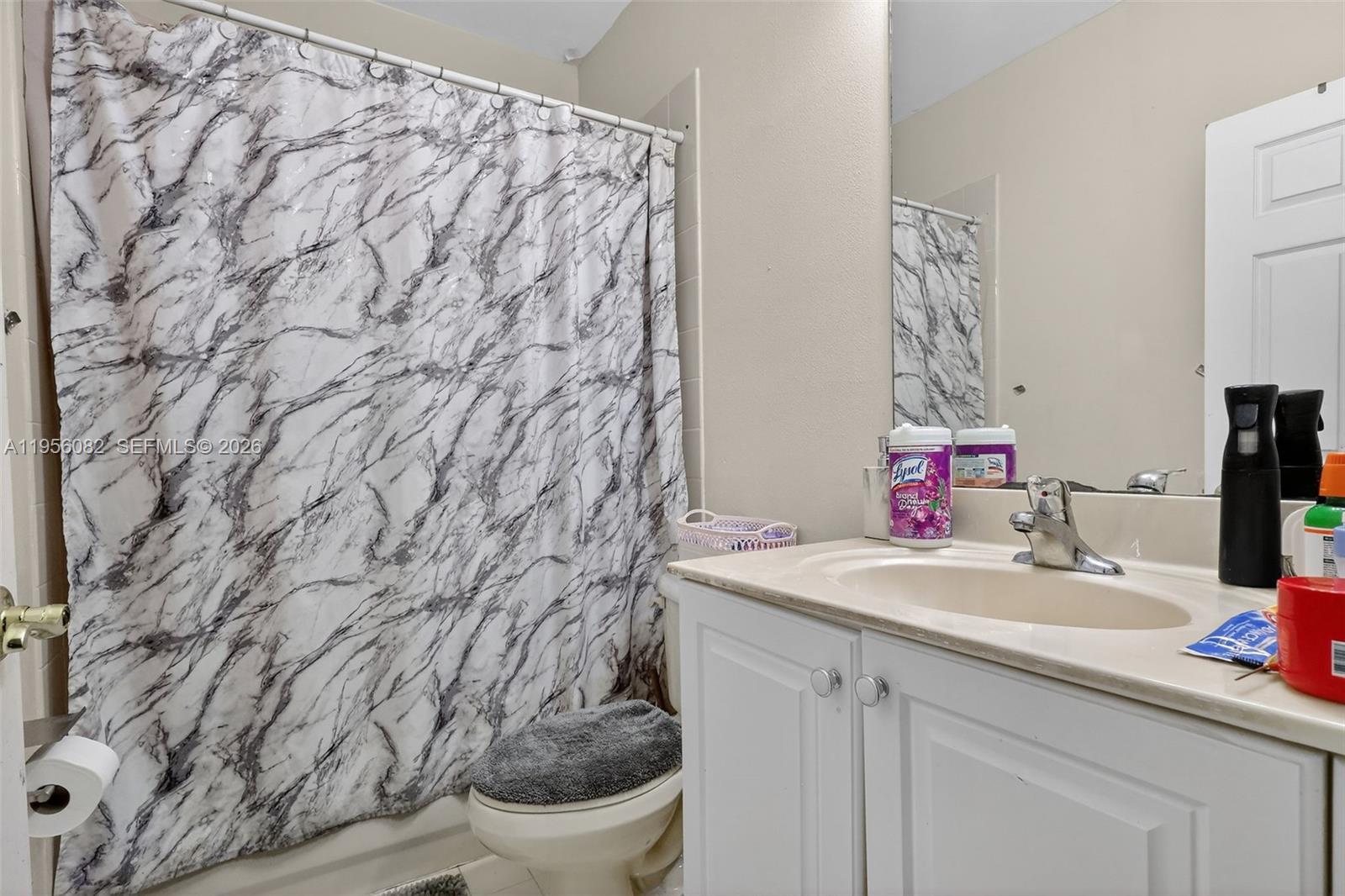 2671 Southwest 85th Terrace, Unit 103 Miramar, FL 33025 - Photo 31 of 49 a bathroom with a sink and a mirror with toilet