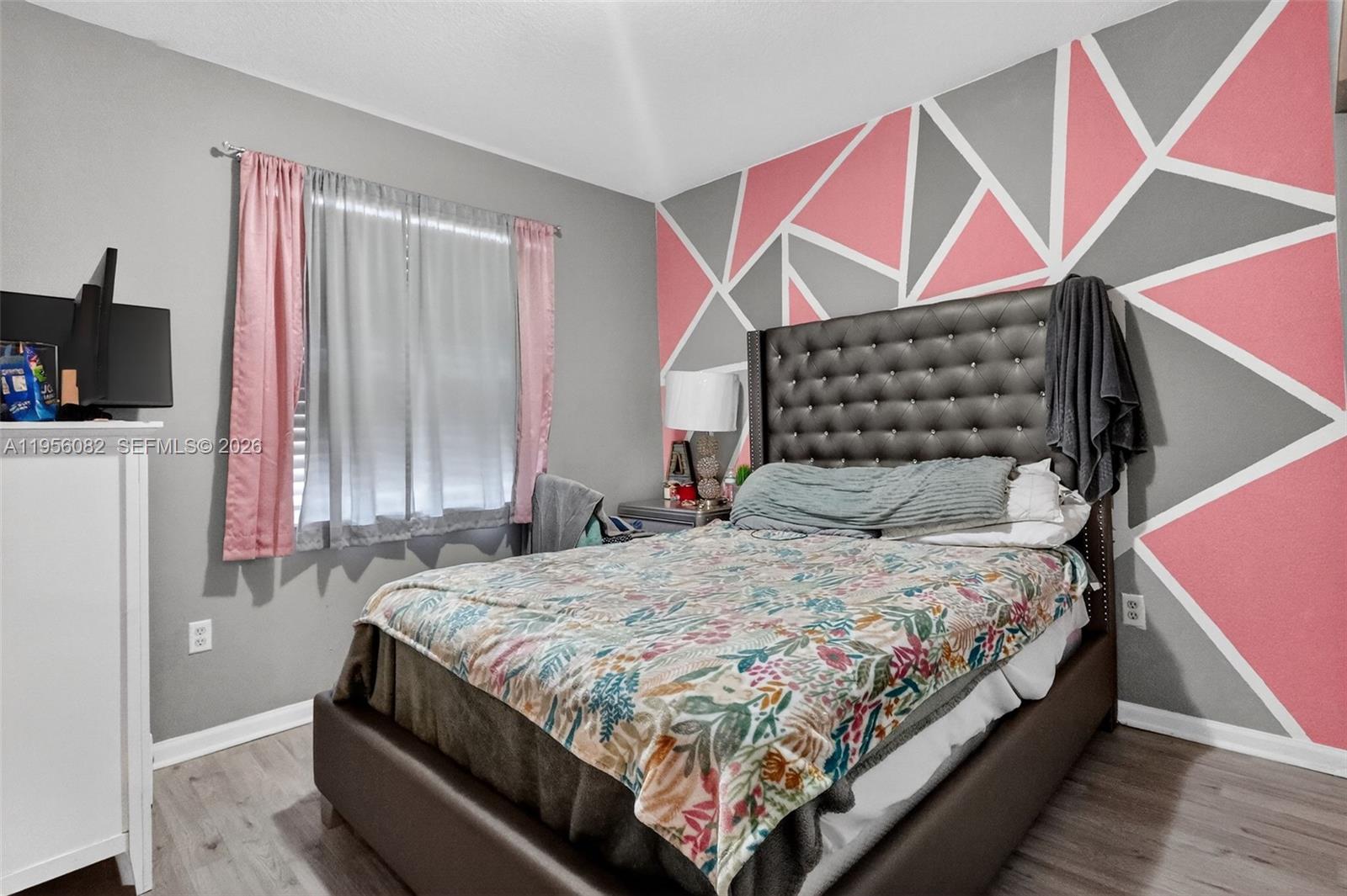 2671 Southwest 85th Terrace, Unit 103 Miramar, FL 33025 - Photo 33 of 49 a bedroom with a bed and a flat screen tv