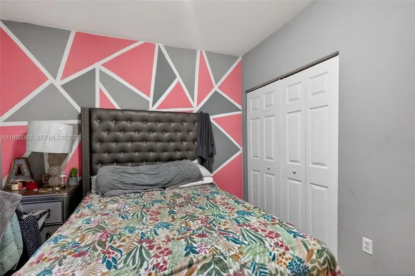 a bedroom with a bed and a closet