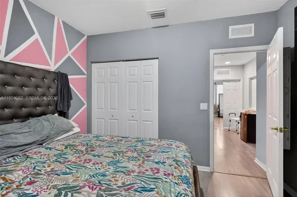a bedroom with a bed and a walk in closet