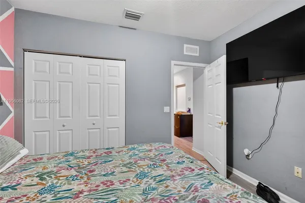 a bedroom with a bed and a flat screen tv