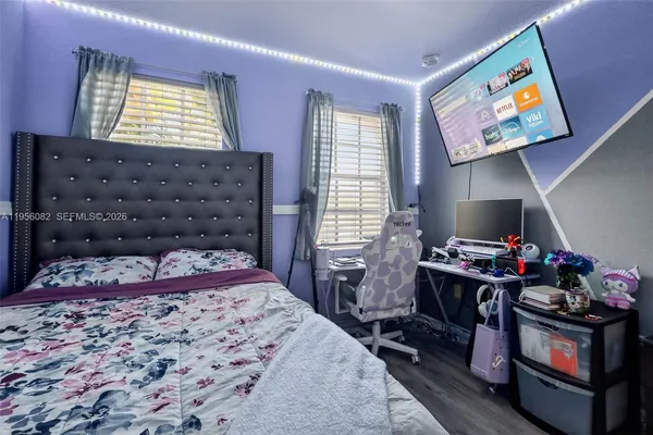 a bedroom with a bed cabinets and window