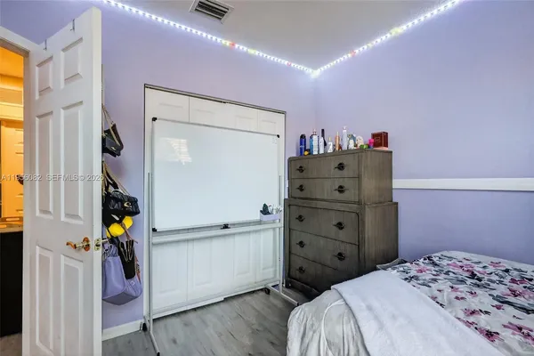 a bedroom with a bed and a dresser
