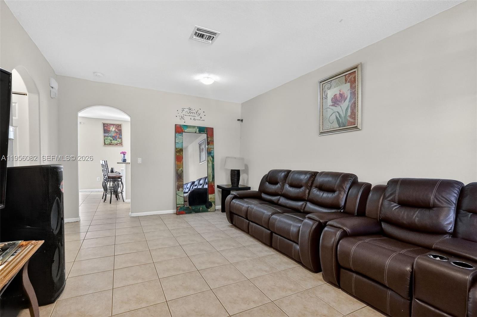 2671 Southwest 85th Terrace, Unit 103 Miramar, FL 33025 - Photo 4 of 49 a living room with furniture and a flat screen tv