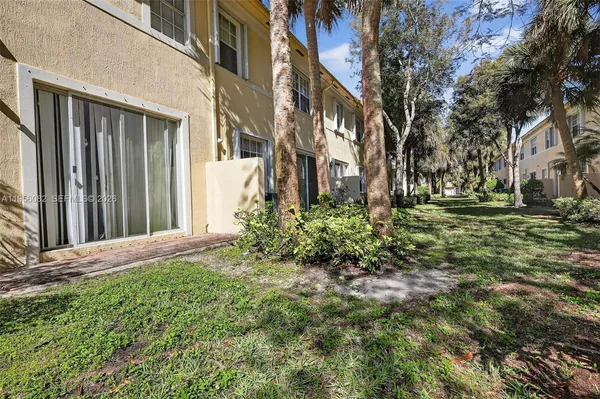 a view of a pathway of a house with a yard