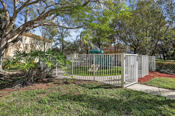 a view of a yard with plants and trees