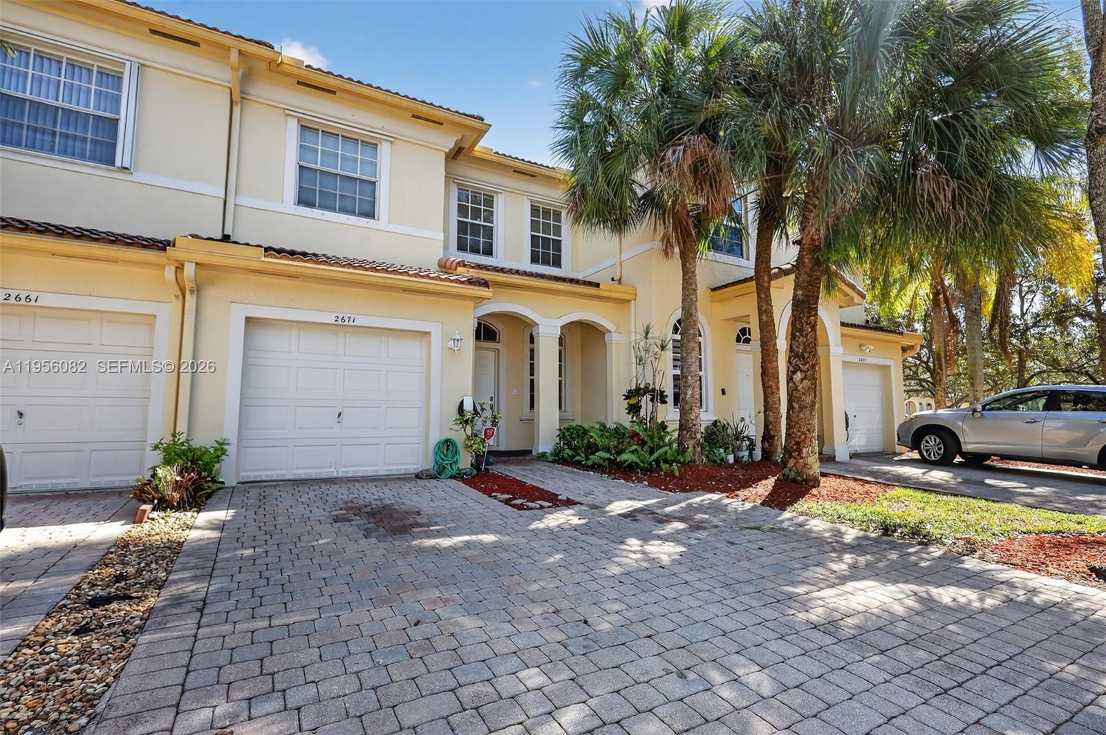 2671 Southwest 85th Terrace, Unit 103 Miramar, FL 33025 - Photo 48 of 49 a front view of a house with garden