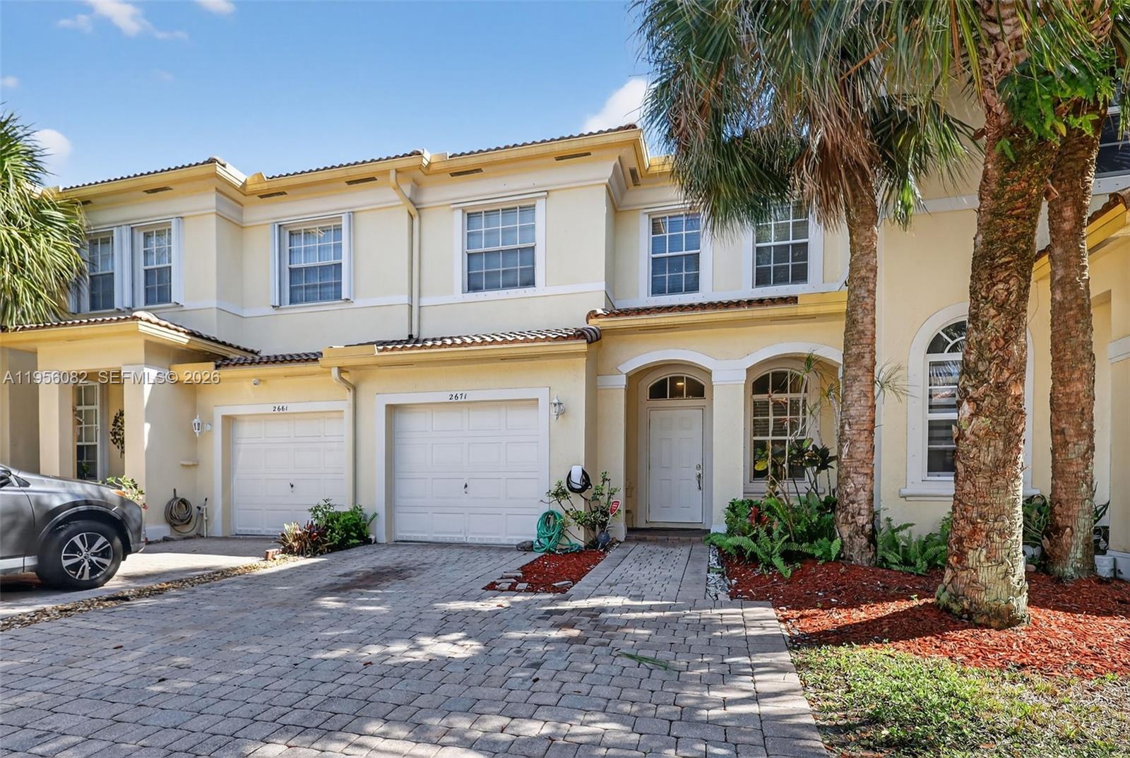 2671 Southwest 85th Terrace, Unit 103 Miramar, FL 33025 - Photo 49 of 49 a front view of a house with garden