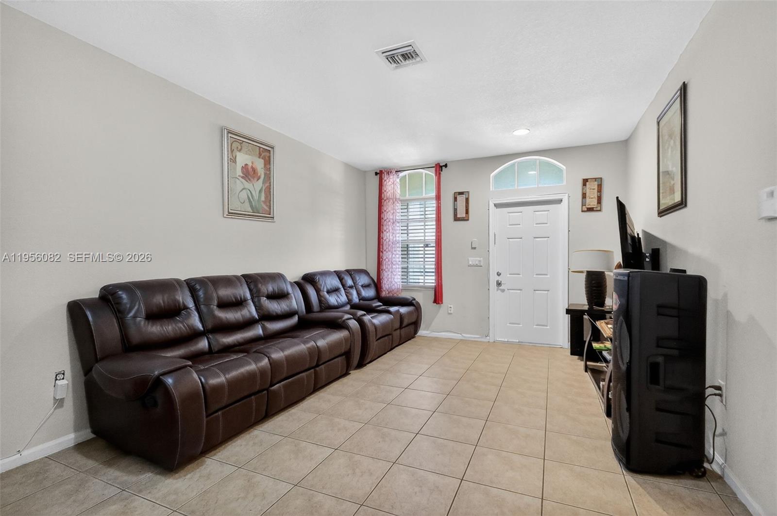 2671 Southwest 85th Terrace, Unit 103 Miramar, FL 33025 - Photo 6 of 49 a living room with furniture and a flat screen tv