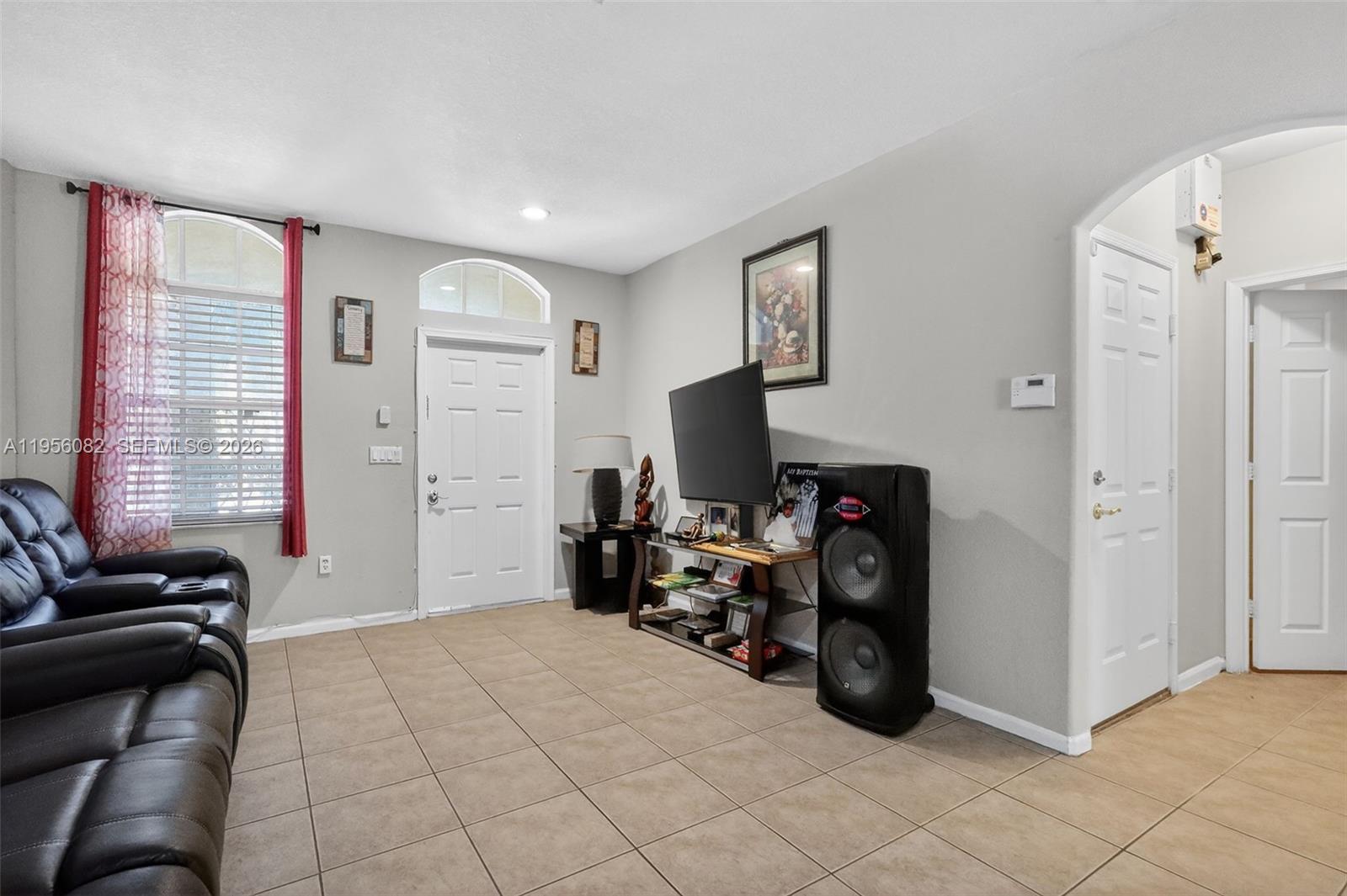 2671 Southwest 85th Terrace, Unit 103 Miramar, FL 33025 - Photo 7 of 49 a bedroom with furniture and a flat screen tv