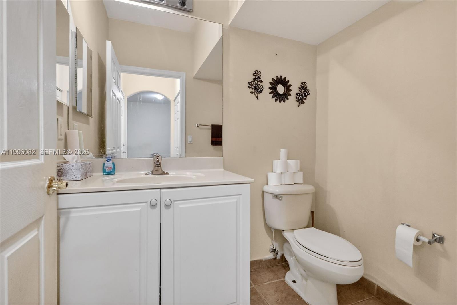 2671 Southwest 85th Terrace, Unit 103 Miramar, FL 33025 - Photo 8 of 49 a bathroom with a toilet sink and mirror