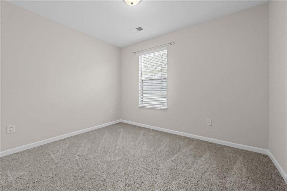 115 Adger Road Pendleton, SC 29670 - Photo 21 of 36 An inviting room with freshly laid carpet and neutral walls, awaiting your personal touch.