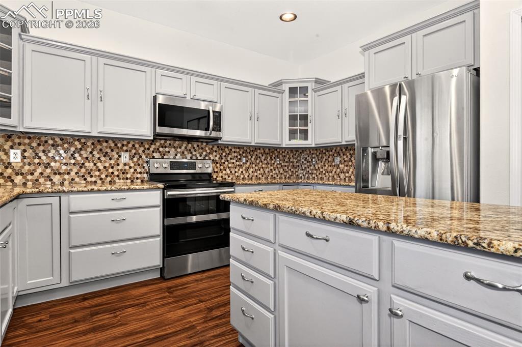 7763 Middle Bay Way Fountain, CO 80817 - Photo 13 of 44 a kitchen with stainless steel appliances white cabinets and a refrigerator
