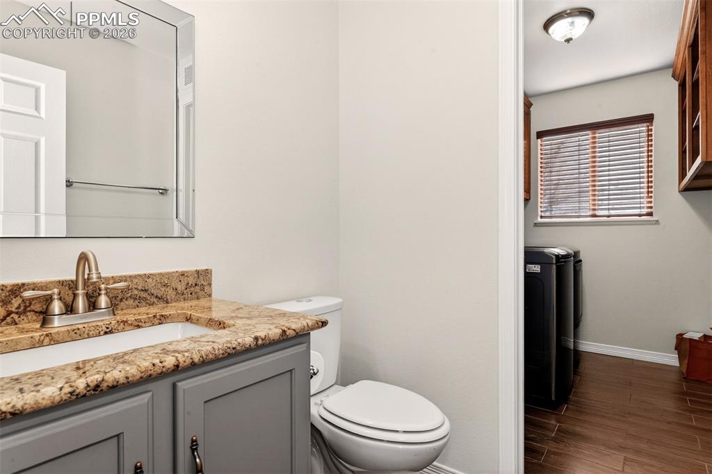 7763 Middle Bay Way Fountain, CO 80817 - Photo 15 of 44 a bathroom with a granite countertop toilet sink and mirror