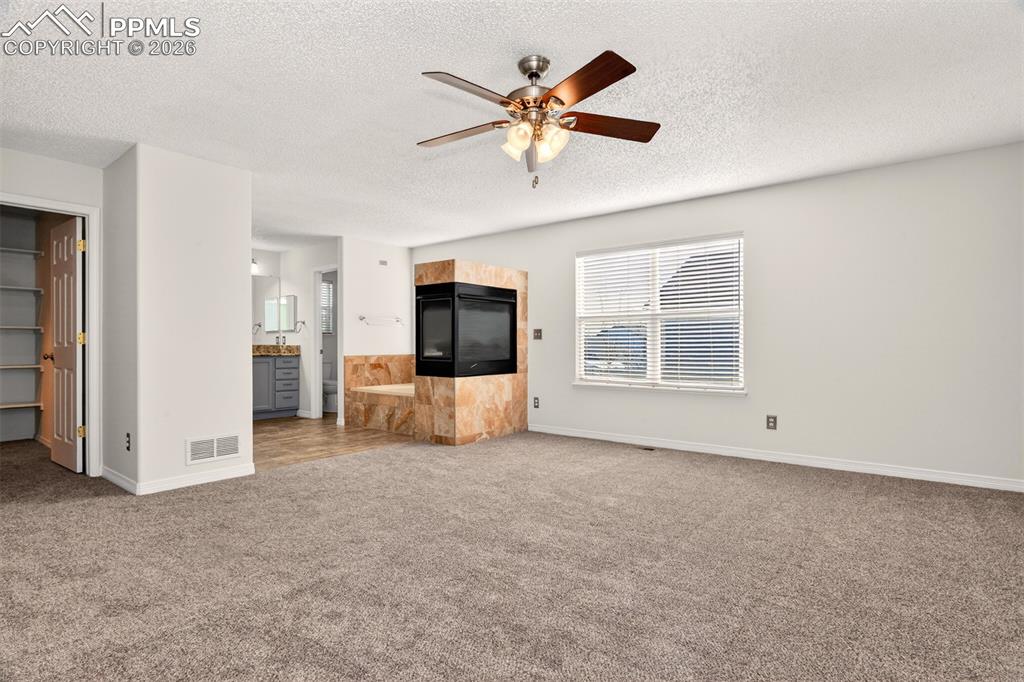 7763 Middle Bay Way Fountain, CO 80817 - Photo 18 of 44 an empty room with chandelier fan and windows