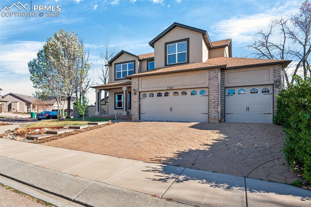 7763 Middle Bay Way Fountain, CO 80817 - Photo 2 of 44 a front view of a house with a yard and garage