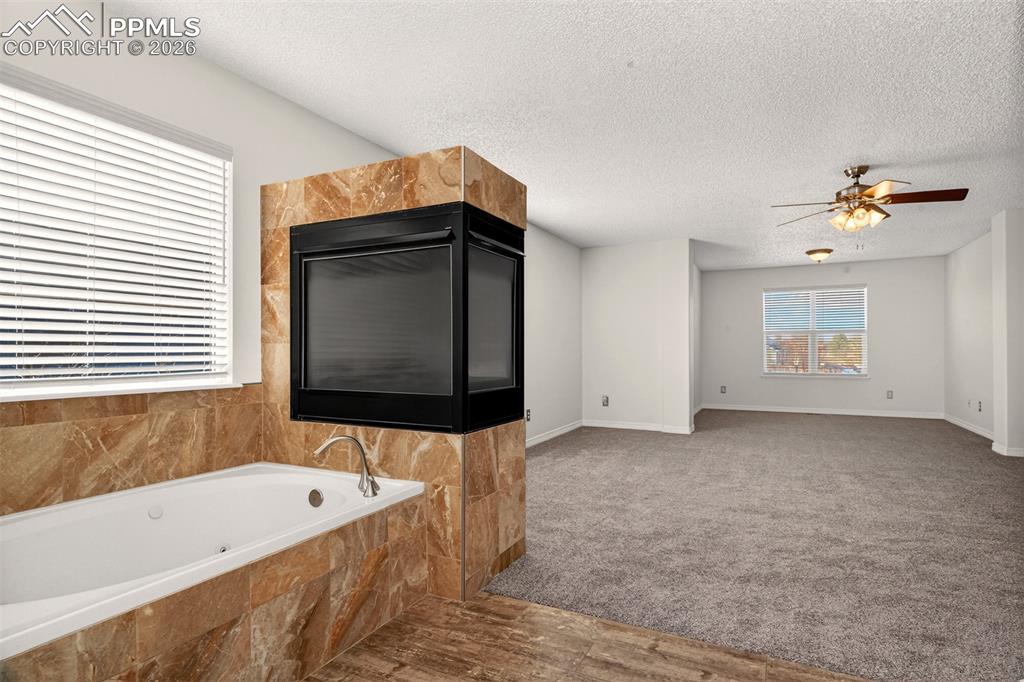 7763 Middle Bay Way Fountain, CO 80817 - Photo 21 of 44 a bathroom with a bathtub and a shower