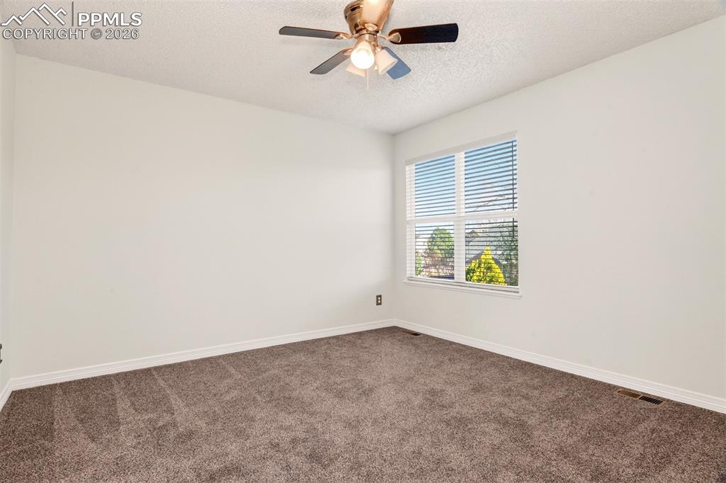 7763 Middle Bay Way Fountain, CO 80817 - Photo 26 of 44 an empty room with windows and fan