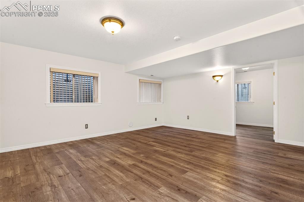 7763 Middle Bay Way Fountain, CO 80817 - Photo 29 of 44 an empty room with wooden floor and windows