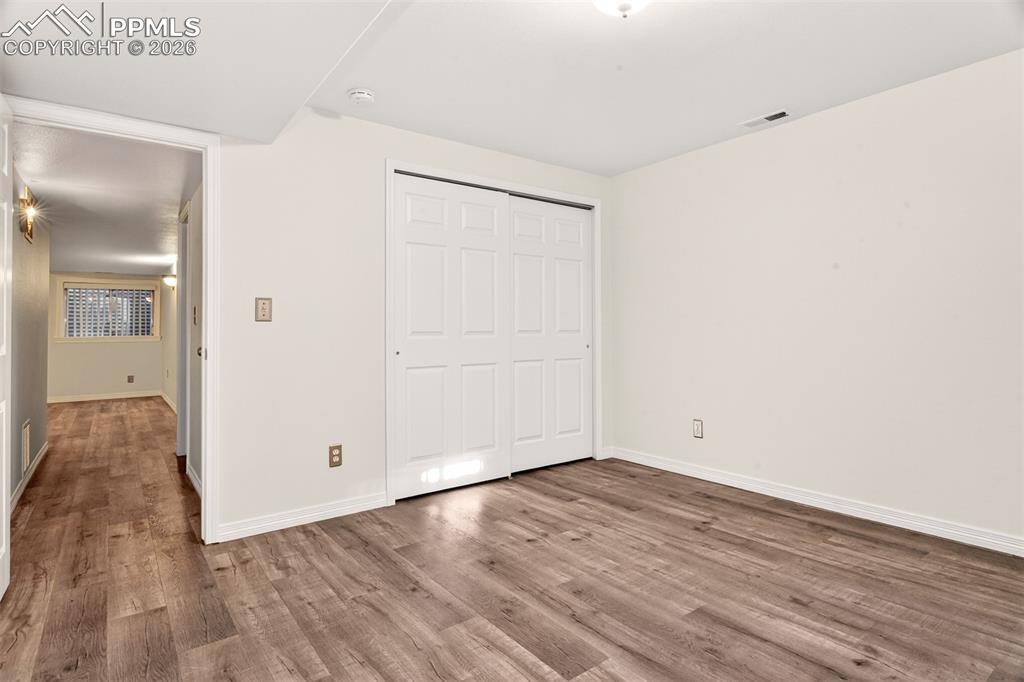 7763 Middle Bay Way Fountain, CO 80817 - Photo 30 of 44 a view of an empty room with wooden floor
