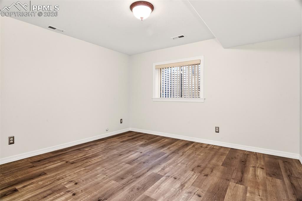7763 Middle Bay Way Fountain, CO 80817 - Photo 31 of 44 an empty room with wooden floor and windows