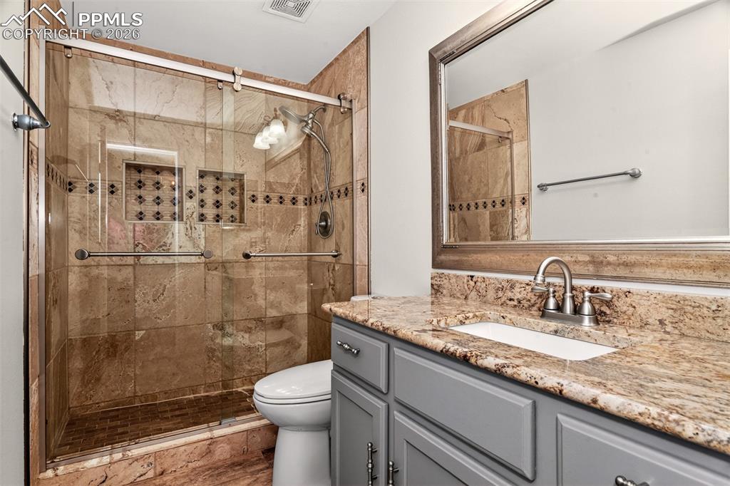 7763 Middle Bay Way Fountain, CO 80817 - Photo 32 of 44 a bathroom with a granite countertop sink toilet and shower