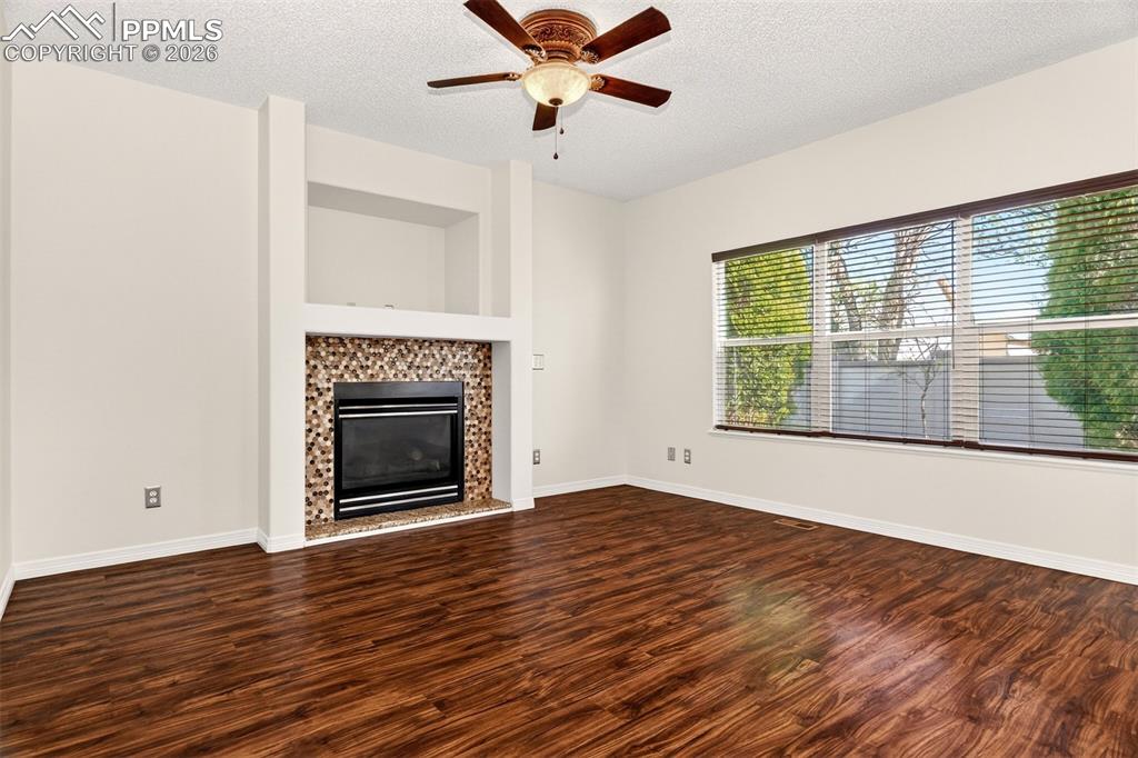 7763 Middle Bay Way Fountain, CO 80817 - Photo 7 of 44 a view of an empty room with wooden floor and a window