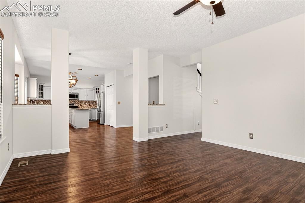 7763 Middle Bay Way Fountain, CO 80817 - Photo 9 of 44 an empty room with wooden floor and windows