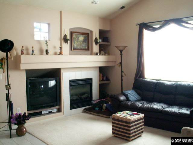 9709 Ripple Way Reno, NV 89521 - Photo 2 of 9 a living room with furniture and a fireplace