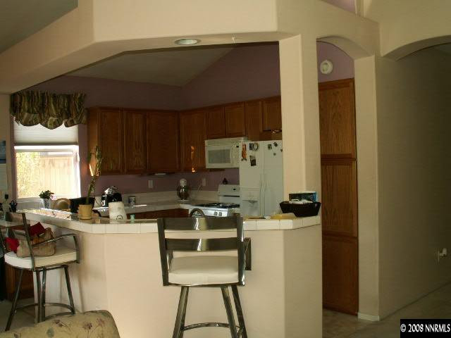 9709 Ripple Way Reno, NV 89521 - Photo 5 of 9 a kitchen with refrigerator and cabinets