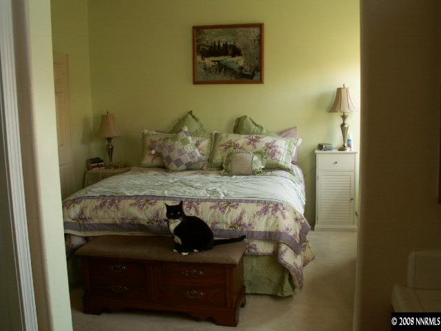 9709 Ripple Way Reno, NV 89521 - Photo 6 of 9 a bed sitting in a bedroom next to a wall
