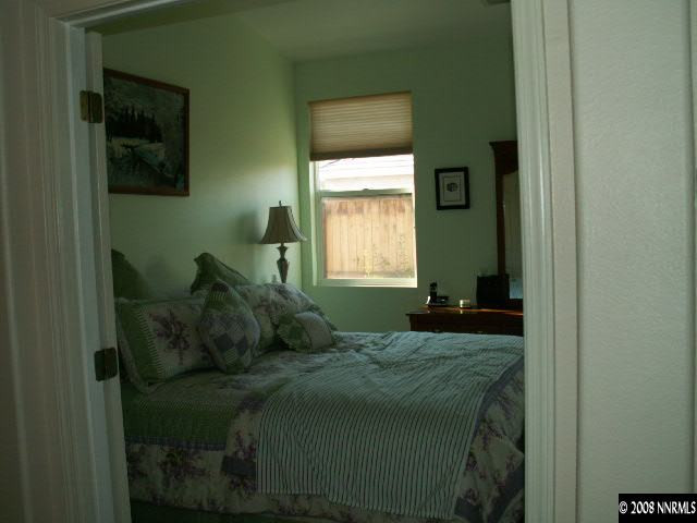 9709 Ripple Way Reno, NV 89521 - Photo 7 of 9 a bedroom with a bed and a window