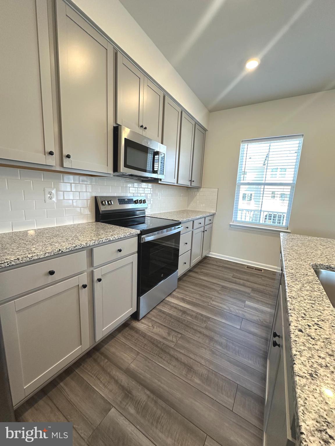 78 Rolling Branch Drive Ranson, WV 25438 - Photo 15 of 49 a kitchen with stainless steel appliances granite countertop a stove a sink and a microwave