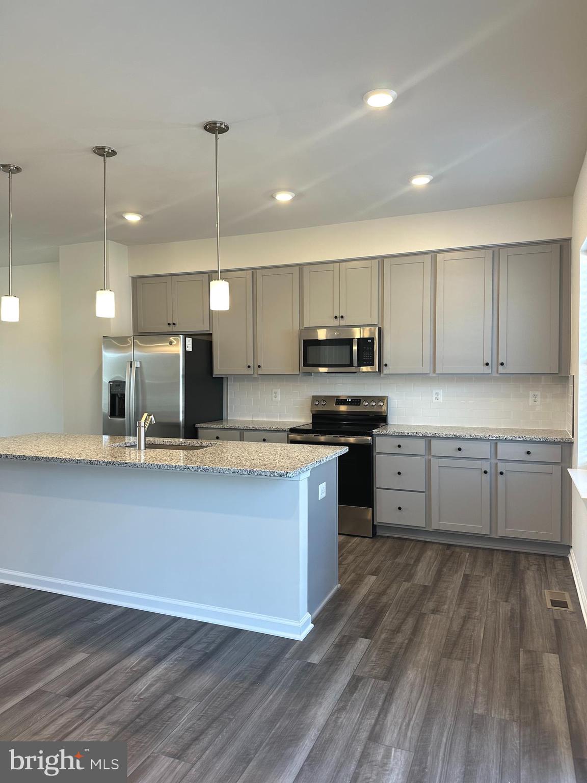 78 Rolling Branch Drive Ranson, WV 25438 - Photo 5 of 49 a large kitchen with granite countertop a sink counter space stainless steel appliances and cabinets