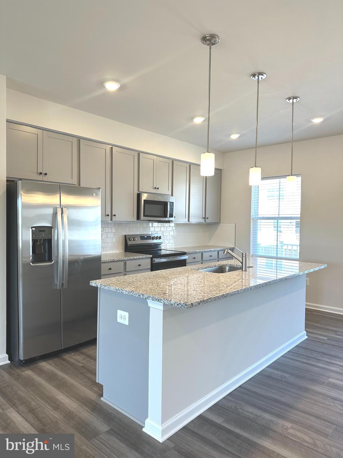 78 Rolling Branch Drive Ranson, WV 25438 - Photo 6 of 49 a kitchen with kitchen island a counter top space a refrigerator a sink and a stove